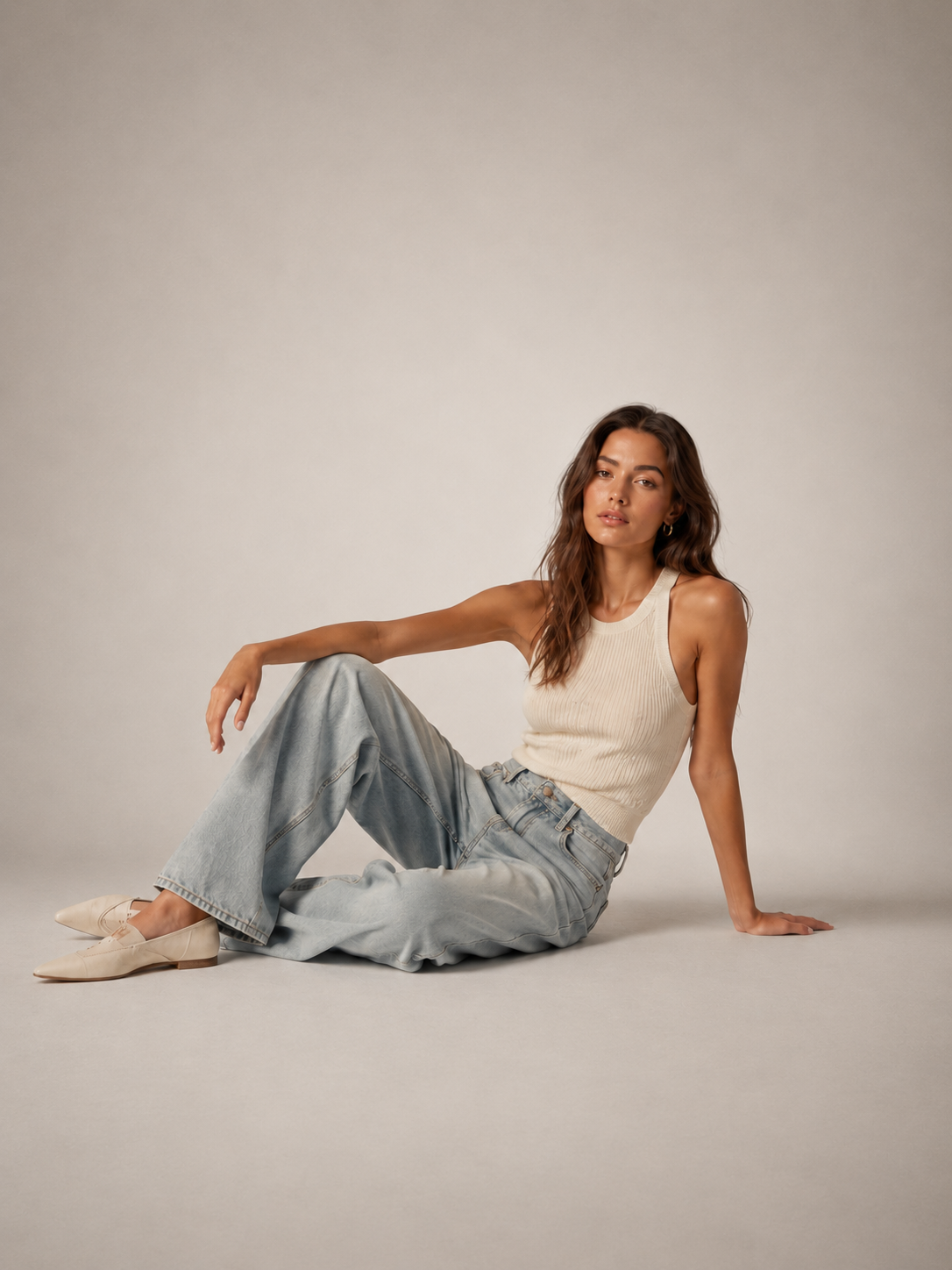 Model in a white crop tee and denim for the women's collection